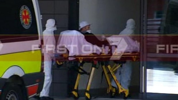 A man suspected of suffering from Ebola is wheeled into the Gold Coast University Hospital.