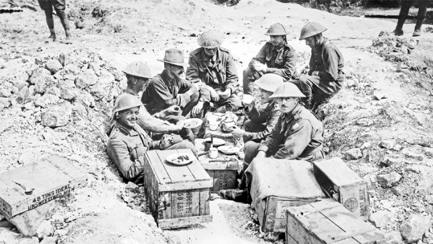 Soldiers having breakfast in a shell hole.