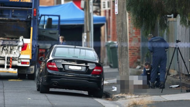 Forensics officers examine the man's body on St Phillip Street.