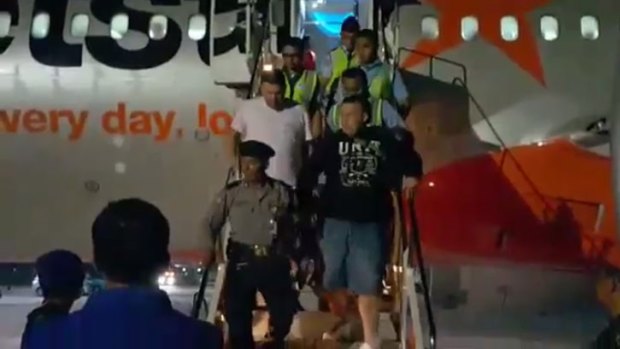 The men being escorted from the Jetstar plane in Bali.