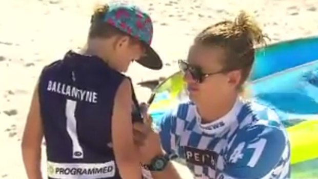 Dockers star Nat Fyfe gives a young Ballantyne fan an autograph after the race.