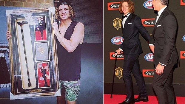 Docker Nat Fyfe with his auction prize for Telethon and right - with the now infamous cane on his Brownlow winning night