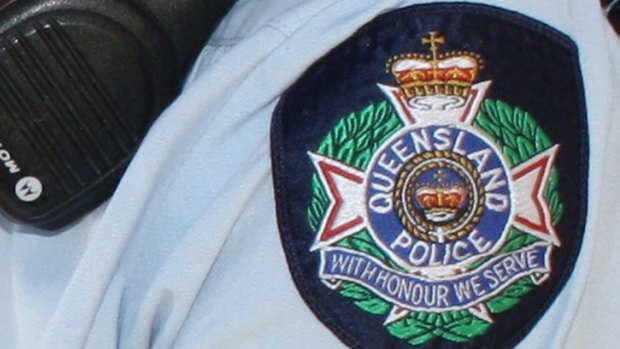 A Queensland police officer has broken his arm during an arrest in Cairns.
