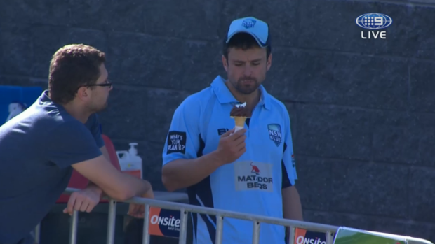 Caught: Ed Cowan is sprung demolishing a choc-top at the Matador Cup game between New South Wales and Queensland