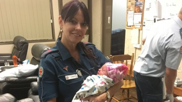 Queensland paramedic Pam with the baby girl. 