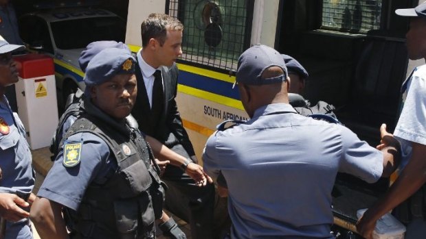 Oscar Pistorius is loaded into a police van after being sentenced to five years' jail time for killing girlfriend Reeva Steenkamp.