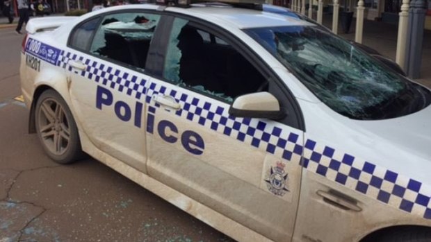 Five police cars had the windows smashed in, as did one local business in the area.
