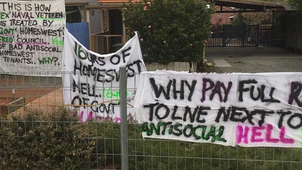 The banners outside Mr Cain's home have been put up to get the government's attention