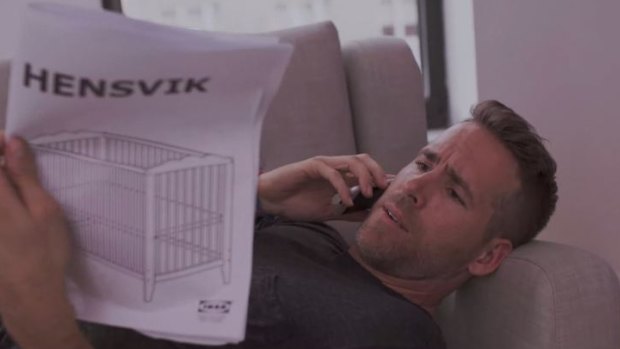 Actor Ryan Reynolds struggling with Ikea's infamous flat pack furniture.