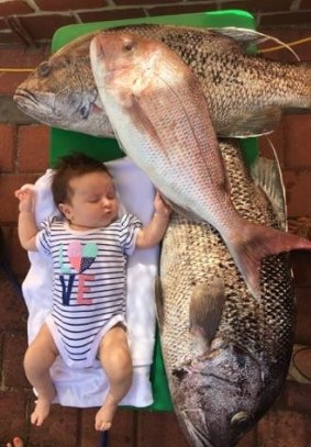 Seven-week-old Brooklyn next to her dad's big catch last week. 
