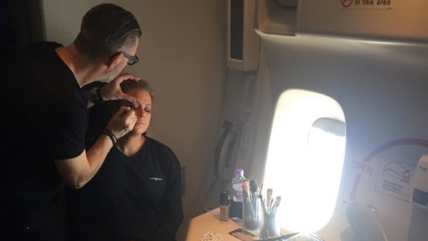 Channel Seven make-up artist Garry Siutz working on Samantha Armytage, on the descent into New York. 