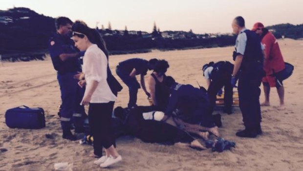 Bodyboarder Dale Carr being treated at the scene after a shark attack at Port Macquarie.
