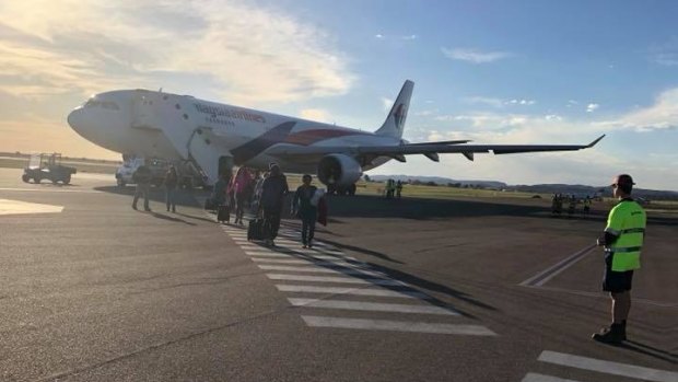 Passengers board flight MH122 in Sydney on Thursday.