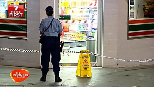 A police officer stands outside a 7_Eleven after a group of teenagers allegedly went on a rampage through Sydney last month.