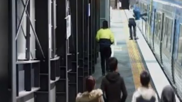 PSOs drag 'Stephen' from a train at Springvale station last year. 