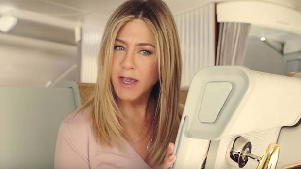 Jennifer Aniston finds a little surprise in her first class seat.