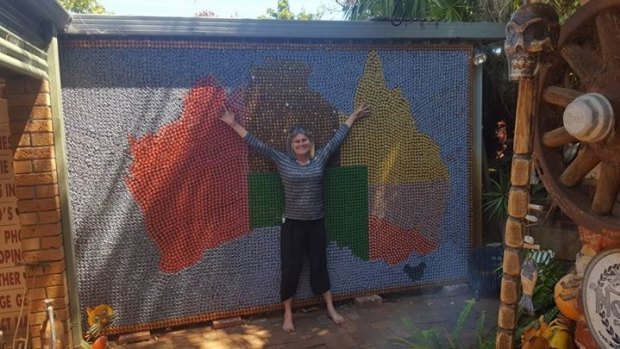 Kim McMeekin proudly shows off her  beer cap map of Australia.