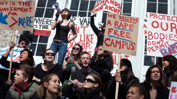 Furore after report: Protesters carry signs and chant slogans in front of the Phi Kappa Psi fraternity house at the University of Virginia, on November 22.