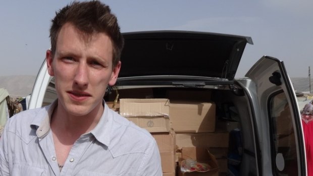 Peter Kassig standing in front of a truck filled with supplies for Syrian refugees. Islamic State militants later beheaded him. 