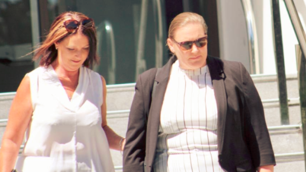 Michelle Haley (right) leaves court on Thursday morning with a supporter.