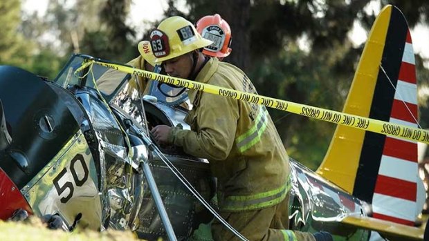 Firefighters inspect the cockpit.