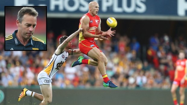 Big leap: Gary Ablett and the Suns stepped it up a gear to put new pressure on Hawks coach Alistair Clarkson (inset).