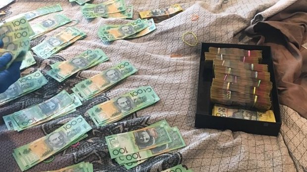 Some of the cash found by police during the raid in the inner city.