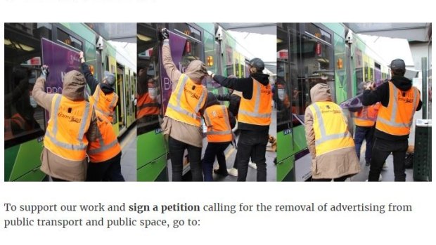 Members of protest group Tram Clean remove advertising from a tram.