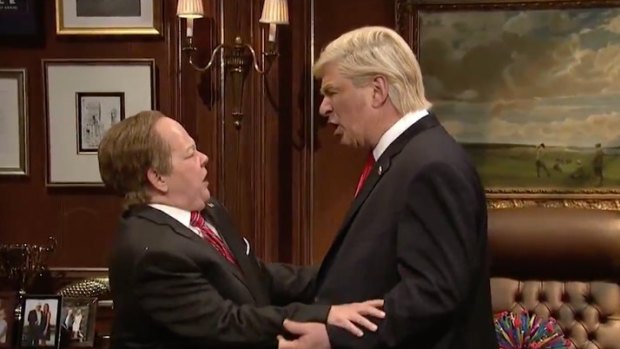 President Donald Trump, impersonated by Alec Baldwin, and Sean Spicer, played by Melissa McCarthy, lock lips on Saturday Night Live.