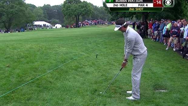 Lie of the land: Bubba Watson lines up his approach shot on the second hole.