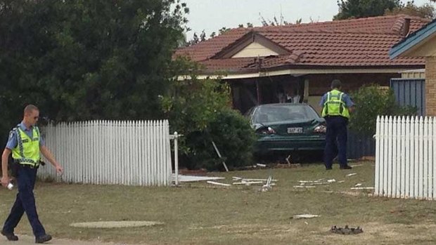 The car appeared to have crashed through a fence before ploughing into the house