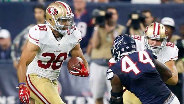 Fearless: Jarryd Hayne rushes past Carlos Thompson of the Houston Texans.
