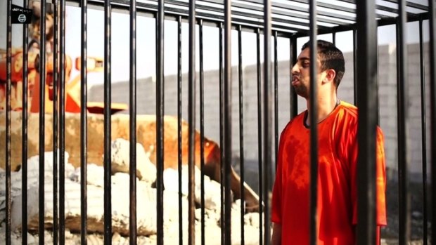 Jordanian pilot Muath al-Kasasbeh in the cage in a video released by Islamic State insurgents.