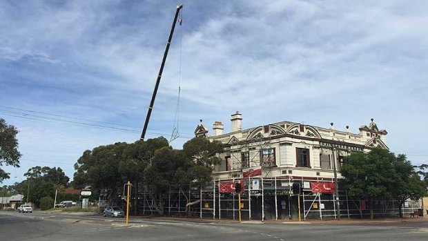 Cranes help place the finishing touches on the roof of the Guildford hotel