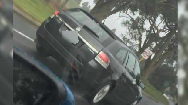 A lewd act was allegedly performed from the rear passenger window of this dark-coloured Holden.