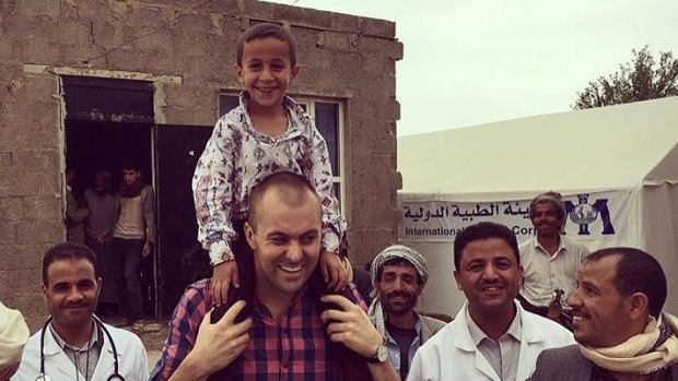Simon Cowie, centre, with the child on his shoulders, in Yemen.
