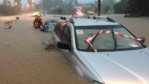 A car under water during severe weather in South East Queensland on Friday.