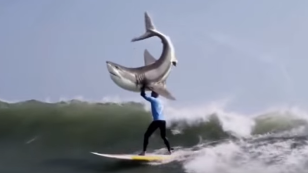 In poor taste? A Mick Fanning lookalike lifts a shark above his head in this ad for a KFC burger.
