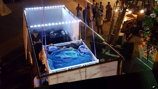 A crane lifts Eman Ahmed's bed in Cairo.