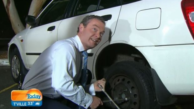 Mr Pyne changes the tyre.