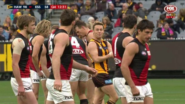 Hawthorn's Sam Mitchell taunts Essendon players, by feigning giving himself an injection.