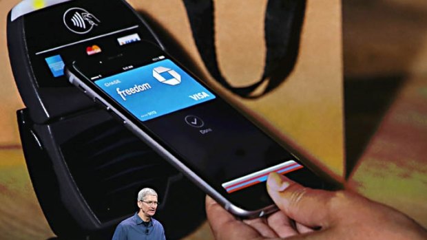 An iPhone 6 with Apple Pay touches an payment terminal.