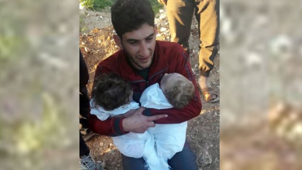 A man holds his twin babies who were killed during the chemical weapons attack in Syria. Trump was said to be impacted by such images.
