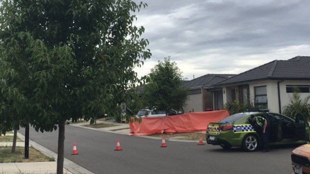 An orange tarpaulin covers the driveway where the woman died in Craigieburn.