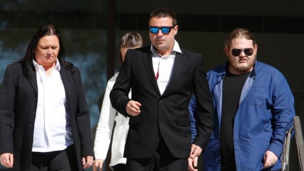Matthew Domio (centre) leaves Wollongong courthouse on Tuesday, flanked by his family.
