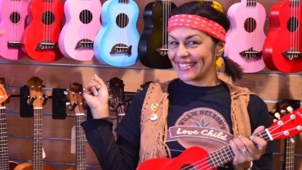 Sandra Beynon of Willie Nelson's Love Child at the Red Hill guitar shop with some of the donated ukuleles.