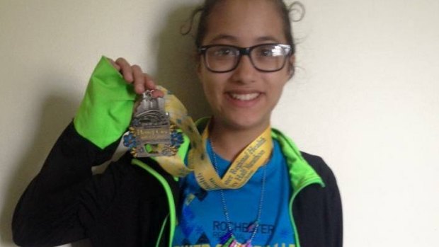 Happy mistake: LeeAdianez Rodriguez shows off her finisher's medal.