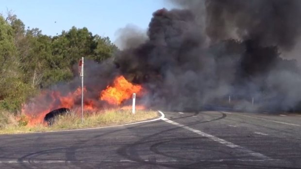A raging fire destroyed the car as it sat in a ditch next to the road.