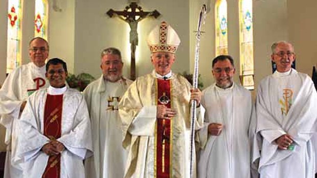 Bishop Les Tomlinson (fourth from left) with Joseph Doyle (far right), photographed more than five years after the Melbourne Response ordered Doyle to stop acting as a priest.