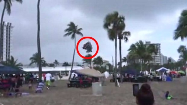 The jumping castle flies through the air at the Florida beach.